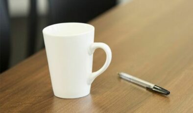 A cup and pen on a table